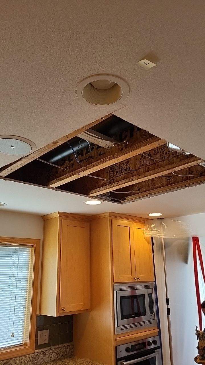 Image of hole in ceiling to attic for cleaning